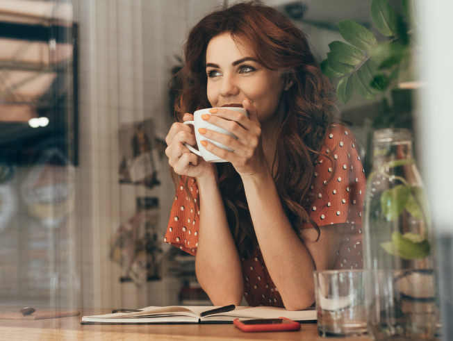 Woman in coffeeshop looking content.